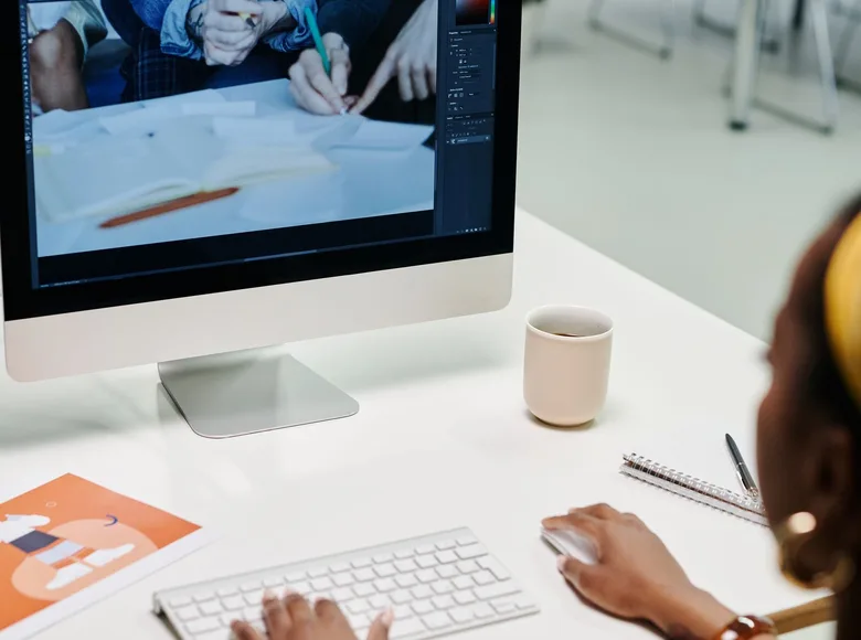Designer refining a user interface layout on a desktop workstation